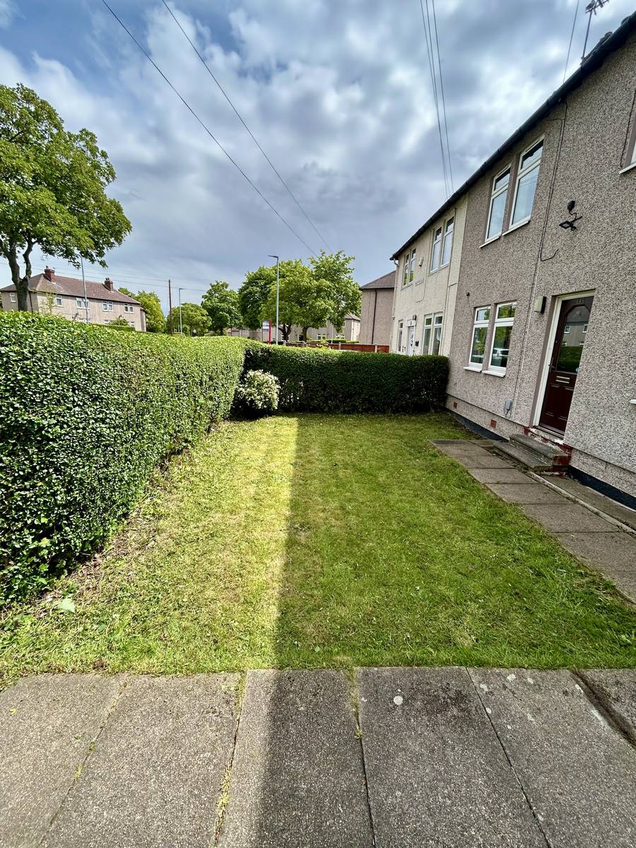 A freshly mown and edged front lawn