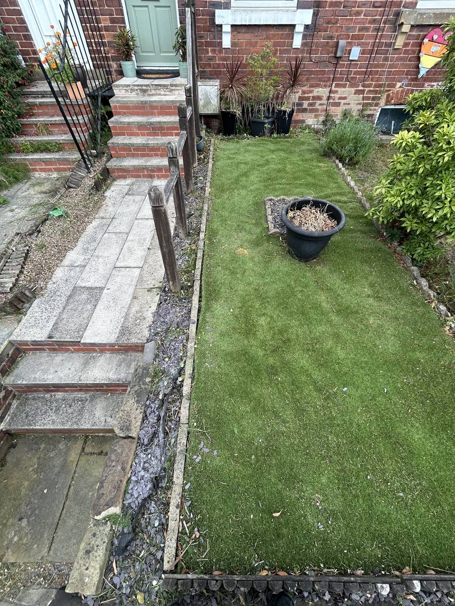A neatly cut lawn and cleared path after a Mills Maintenance visit